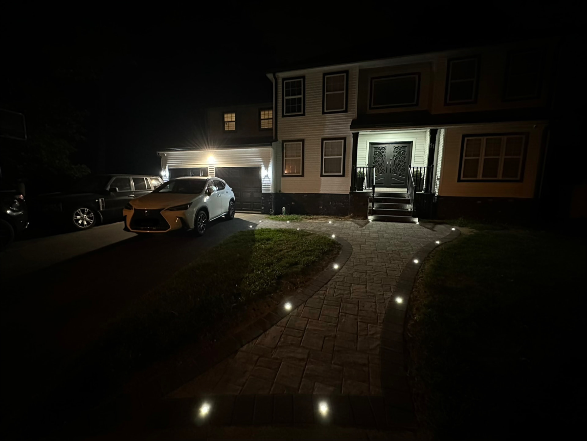 Front entry walkway with landscape lighting after