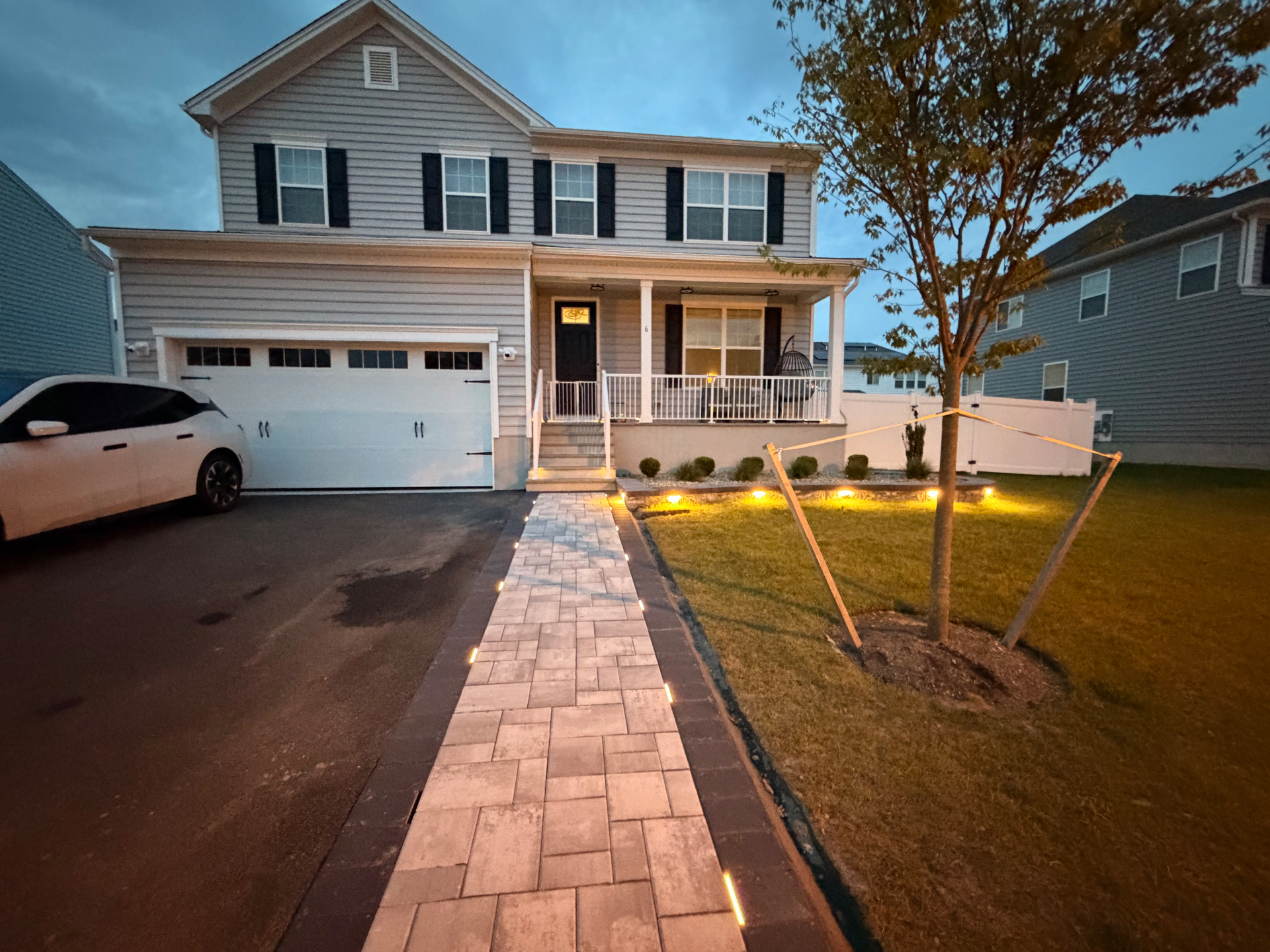 Lit paver walkway at dusk